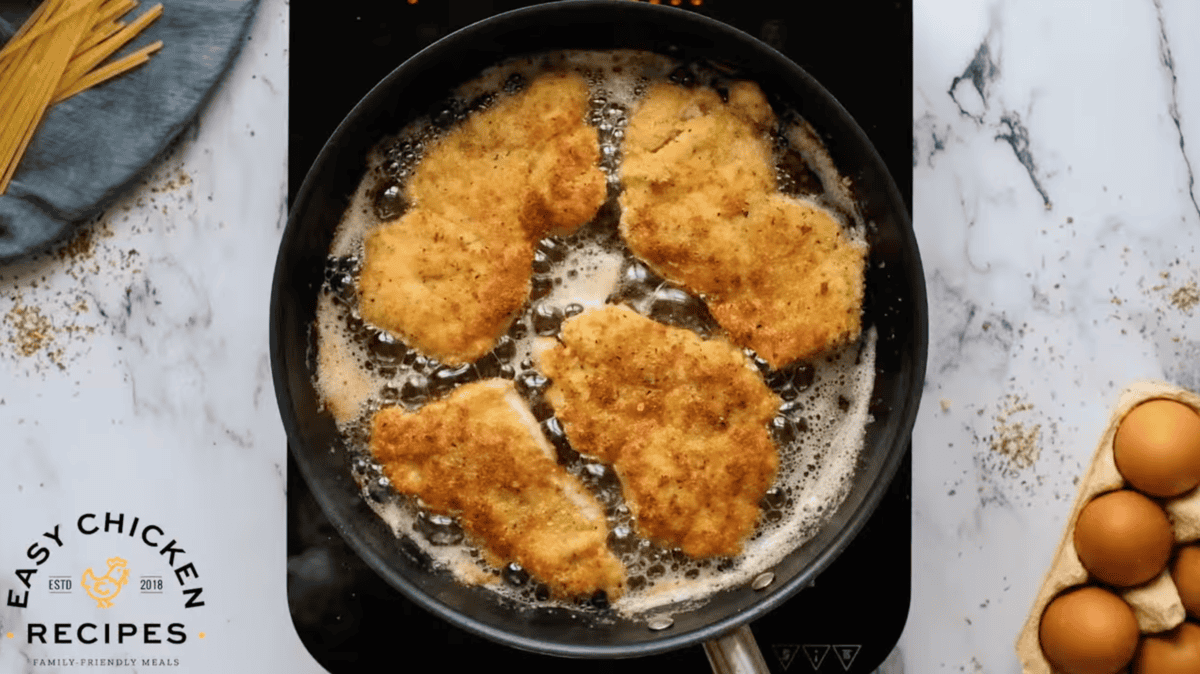 breaded chicken thighs frying in oil.