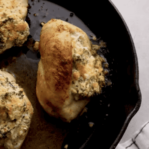 Broccoli and cheese stuffed chicken breasts in a skillet.