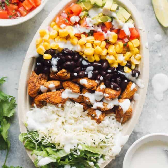 layered chicken burrito bowl next to ingredients