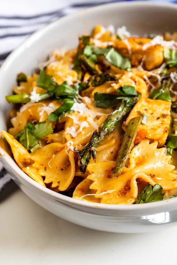 Close up overhead shot of sun-dried tomato pesto pasta in a bowl