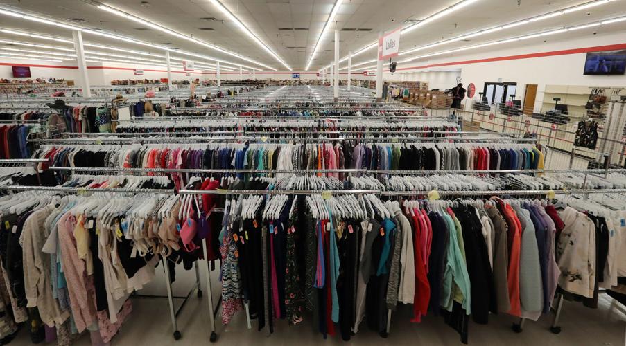 numerous clothing racks inside large store