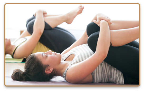 Woman practices asana during group Yin yoga class