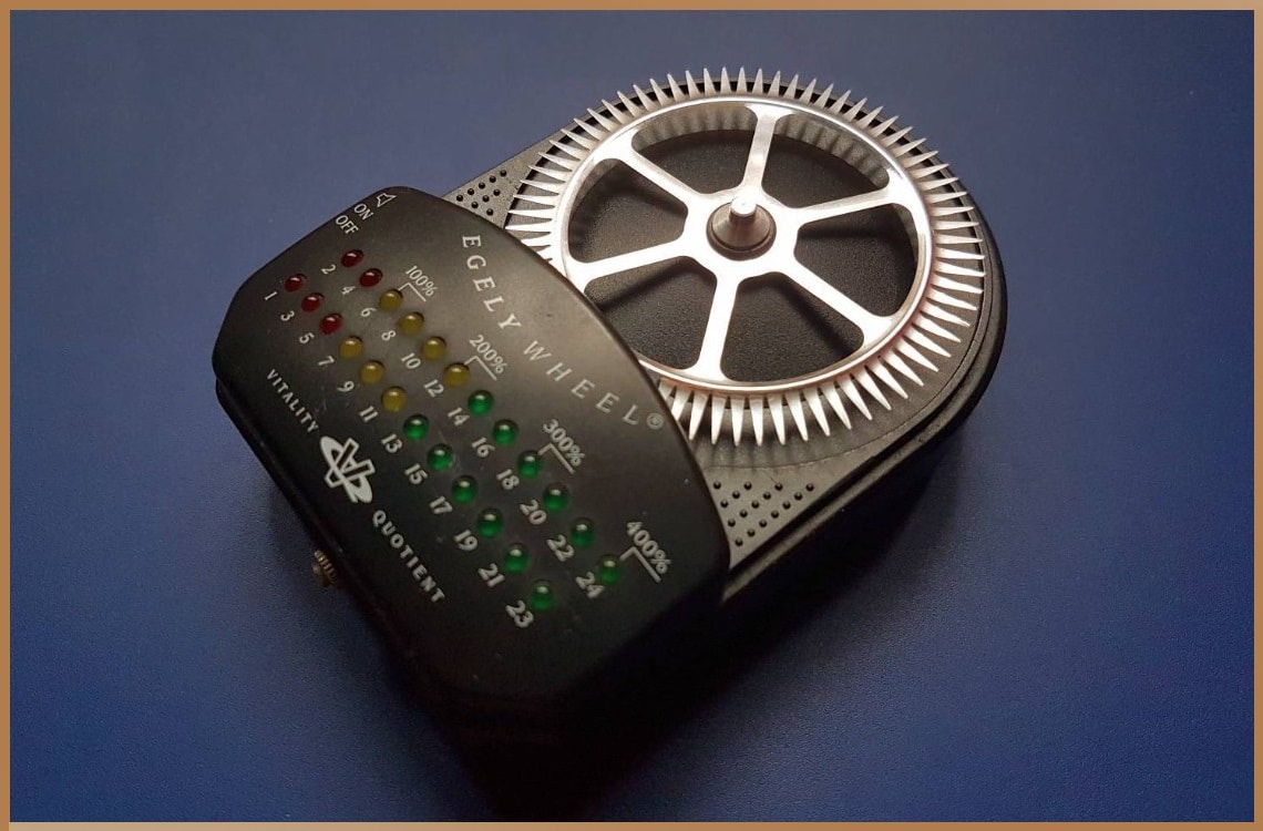 Egely Wheel device against a blue background, used for measuring human vitality and mental state correlations.