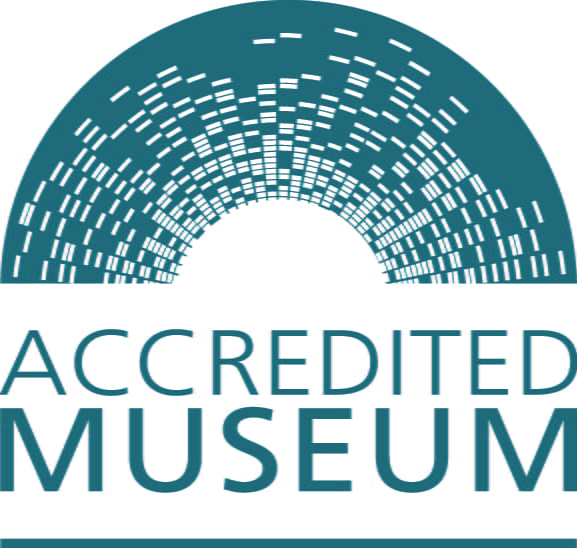 Accredited Museum logo, featuring a teal arc with white stripes and the text "ACCREDITED MUSEUM" below.