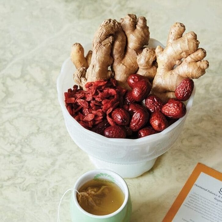 Ginger and berries in a dish on a table.