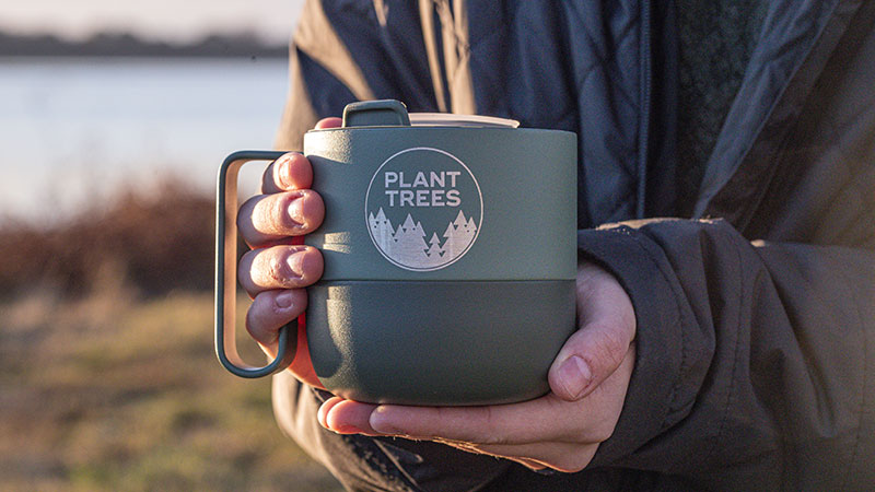 mug with lid that reads plant trees