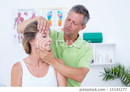 Stock Photo: Doctor doing neck adjustment