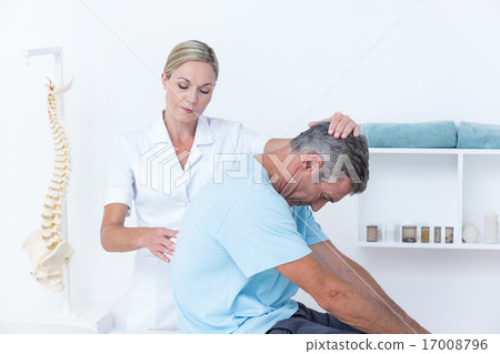 Stock Photo: Doctor stretching a man back