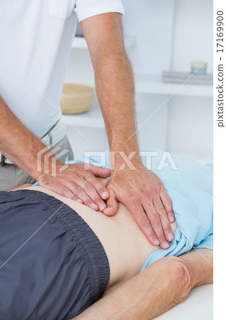 Stock Photo: Physiotherapist doing back massage