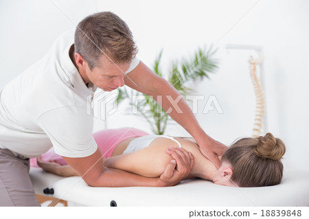 Stock Photo: Physiotherapist doing neck massage to his patient