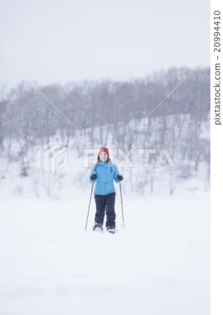 A woman taking a snowshoe 20994410