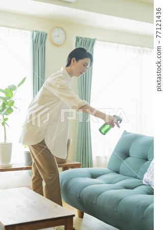 Woman cleaning the room 77121436