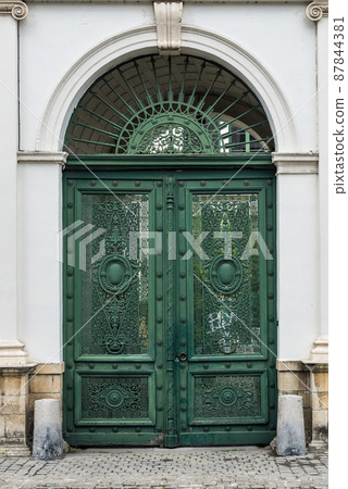 Tournai Doornik, Walloon Region - Belgium - Detail of a worn metal entrance door 87844381