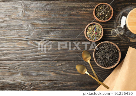 Concept of cooking tea with different types of tea on wooden background 91236450