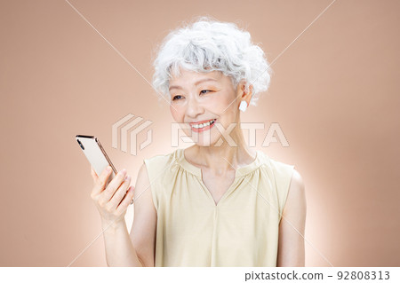 Senior women with a smartphone 92808313