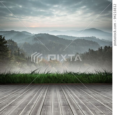 Mountain range beyond wooden floor 94218812