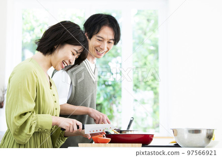 young couple cooking 97566921