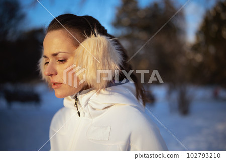 active woman in white jacket with ear warmer 102793210