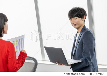 Young businessman having a meeting with a laptop 103332968