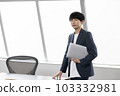 Portrait of young businessman with laptop 103332981