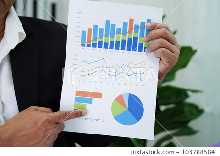 Business woman working and analysis with statistic graph in office. 103788584