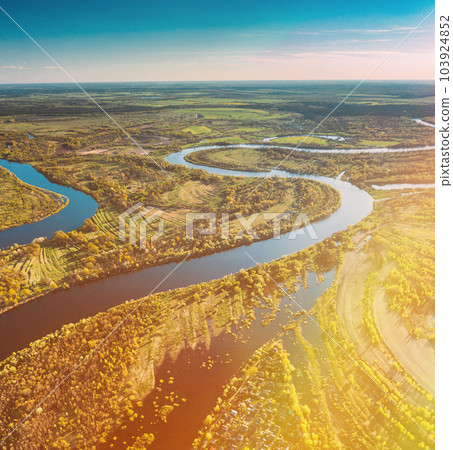 Village Near River, Aerial View Green Forest Woods And River Landscape In Sunny Spring Summer Day. Top View Of Nature, Bird's Eye View. Trees Standing In Water During Spring Flood floodwaters. woods 103924852