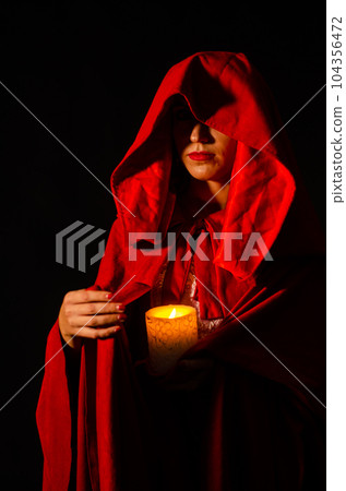 beautiful woman red cloak with red flowers roses in studio. Woman Red Riding Hood. Dramatic and fantastic shooting,fashionable toning. Like a princess 104356472