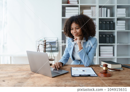 A young women African American lawyer lawsuit studying cases for clients in a law firm to fight against their parties in the courts. law and attorney concepts 104915631