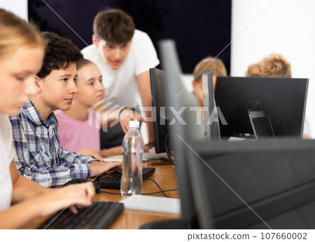 Boy student learning to work on computer in classroom 107660002