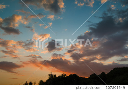 Beautiful orange sunset sky with clouds 107801649