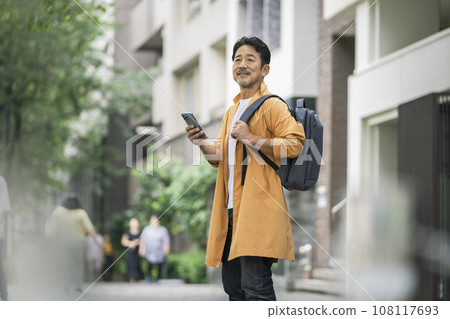 A man in his mid-50s with a smartphone 108117693