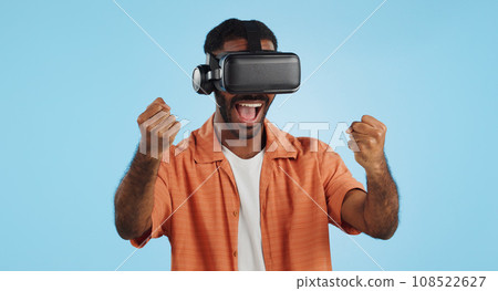 Gamer man, virtual reality and glasses in studio with hand, click and swipe in metaverse by blue background. Person, AR vision and futuristic 3D user experience with grab, cyber ui and digital world 108522627