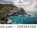 Stunning view of Manarola village in Cinque Terre National Park, beautiful cityscape with colorful houses and green terraces on cliffs over a sea, Liguria region of Italy. 109364388