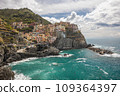 Stunning view of Manarola village in Cinque Terre National Park, beautiful cityscape with colorful houses and green terraces on cliffs over a sea, Liguria region of Italy. 109364397