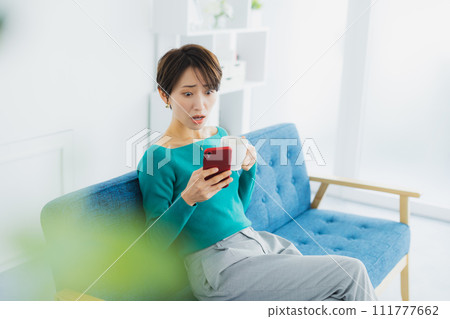 A woman watching a smartphone 111777662