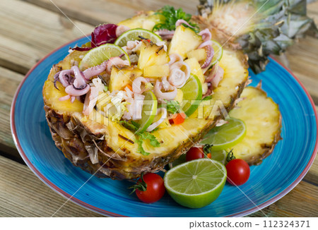 Salad with calamari, pineapple and lime 112324371