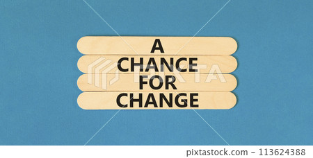 A chance for change symbol. Concept words A chance for change on wooden stick. Beautiful blue table blue background. Business A chance for change concept. Copy space. 113624388