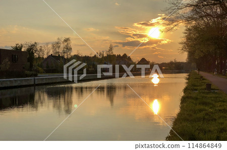 Tranquil Sunset Over a Serene Canal with Reflective Waters and Peaceful Surroundings 114864849