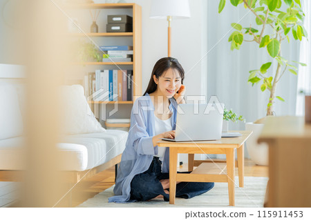 Young woman working on a laptop at home 115911453