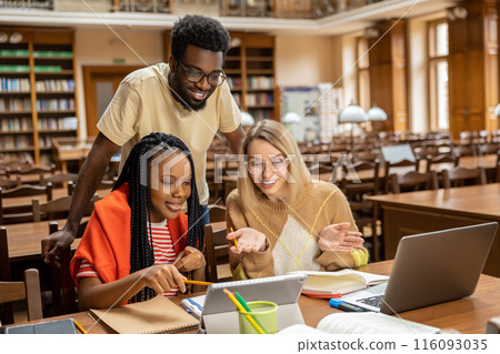 Group of young people working together and looking involved 116093035