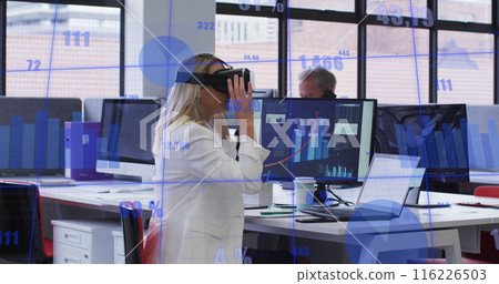 Image of statistical data processing against caucasian woman wearing vr headset at office 116226503