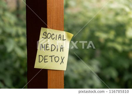 SOCIAL MEDIA DETOX text on paper note on background of greenery garden wooden alcove outdoor. Concept of social media technology detox. Farmcore nature core slow life 116785810