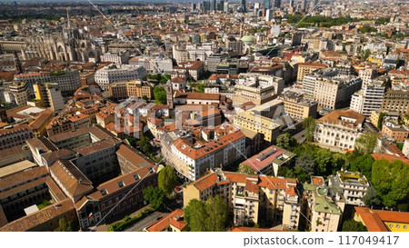 Roof of the University of Milan and city buildings top down view. Milan cityscape against a background of blue sky, view from above in sunny weather 117049417