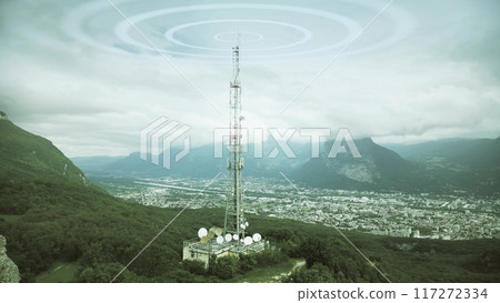 Aerial view of a 5G mobile network antenna emitting radio signals against urban background. Grenoble, French Alps, France. Electromagnetic wave visualization. 117272334