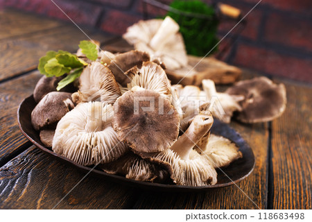 Pile of fresh mushrooms on wooden table 118683498