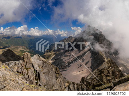 Panoramic Alpine View with Majestic Peaks and Cloud Cover 119808702