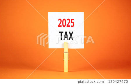 Planning 2025 tax new year symbol. Concept words 2025 Tax on beautiful white paper on wooden clothespin. Beautiful orange background. Business 2025 tax new year concept. Copy space. 120427470