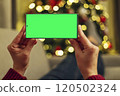 Hands holding smartphone with green screen 120502324