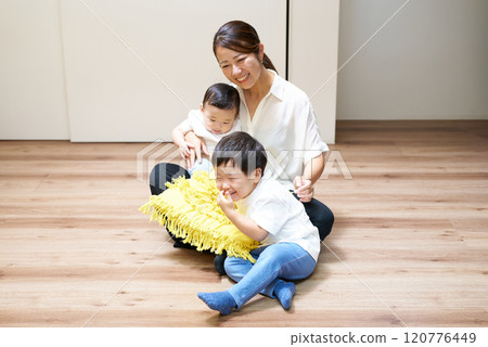 Parents and children playing happily in the room 120776449