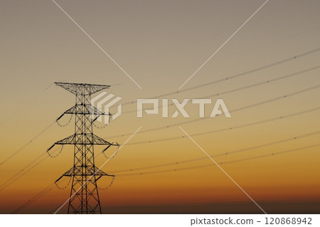 Sunset sky and electricity transmission tower 120868942